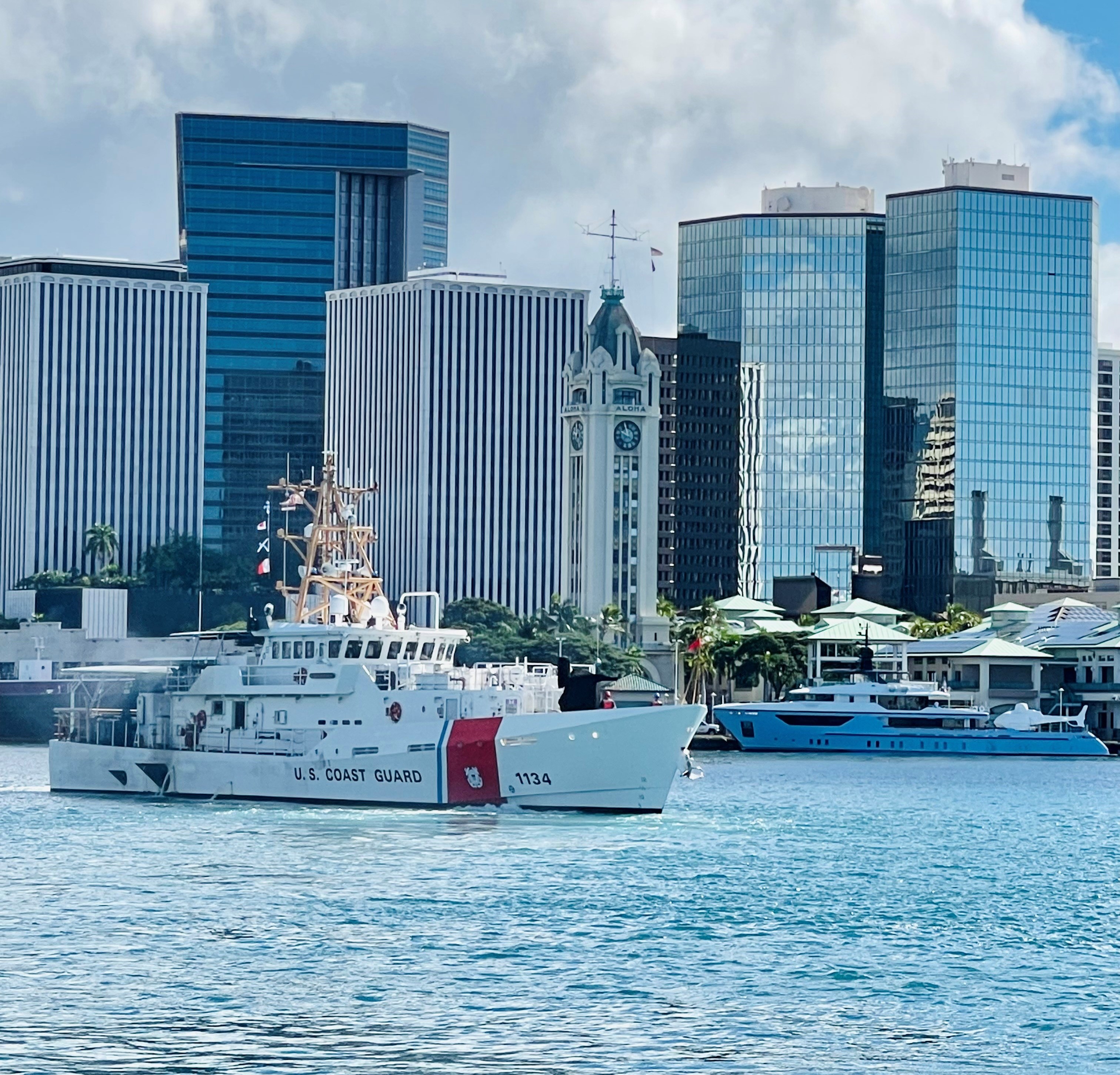 Photo of CGC William Hart with the Aloha Tower in the background